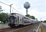 Eastbound NJT Train # 4732, with a Multilevel Set, approaching the Atlantic Avenue Grade Crossing with the Point Pleasant Beach water tower in the background 